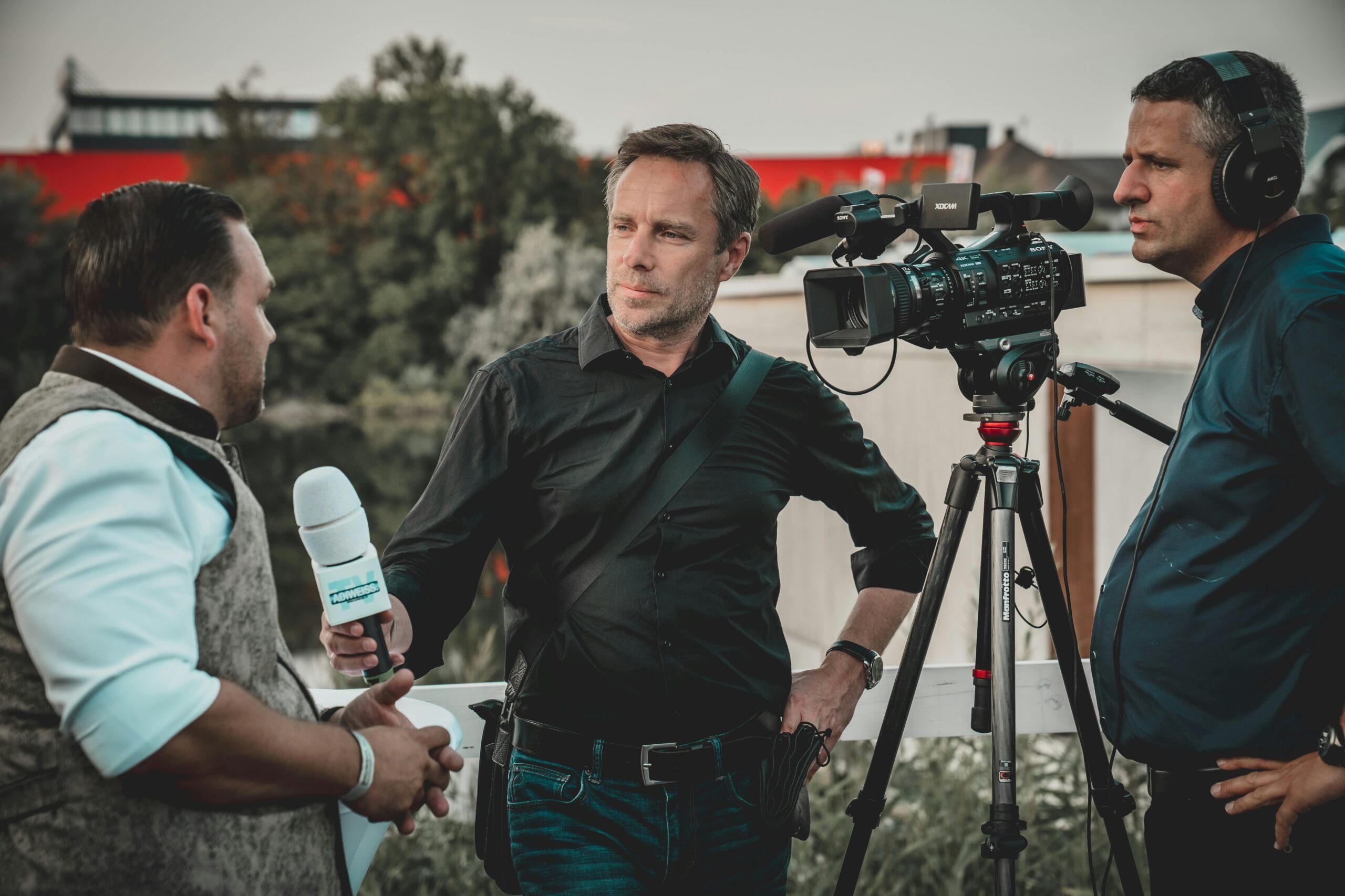 Services Outdoor interview with a professional news crew capturing footage using high-tech equipment.